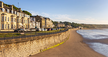 a view of the houses in Filey facing the seafront and beach