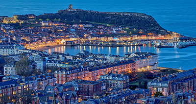 a high-up view of Scarborough at twilight