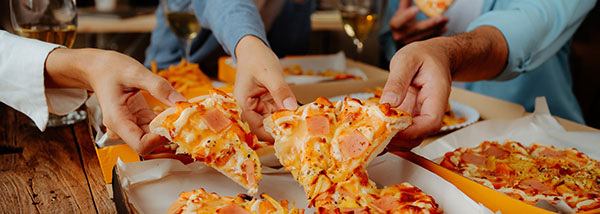 a group of people sharing pizza together