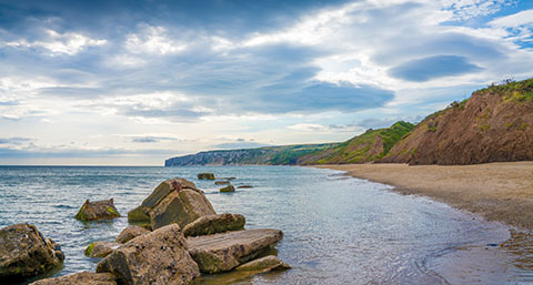a view of Reighton Sands coast with cliffs in the horizon