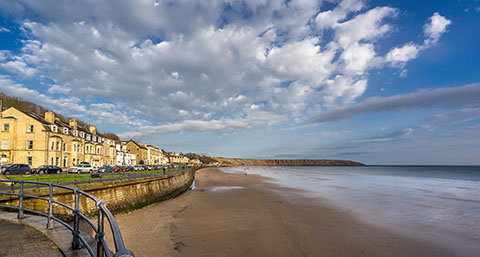 a view of Filey beach with Filey Brigg in the horizon