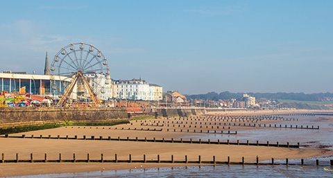 a view of Bridlington beach, fair and town in the background from Bridlington Pier