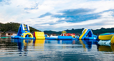 an inflatable water park on a lake